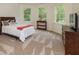 Bright bedroom featuring neutral walls, carpet floors, and large windows overlooking a green space at 930 Shepards Ct, Roswell, GA 30075