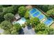Aerial image shows a community pool, tennis courts, and clubhouse surrounded by mature trees at 930 Shepards Ct, Roswell, GA 30075