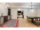 Open dining area with hardwood floors, modern lighting, a wet bar and view of a living space through sliding doors at 930 Shepards Ct, Roswell, GA 30075