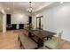 Open dining area with hardwood floors, modern lighting, a wet bar, and backyard view at 930 Shepards Ct, Roswell, GA 30075
