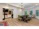 Spacious dining area features hardwood floors, tray ceiling, modern lighting, and backyard view at 930 Shepards Ct, Roswell, GA 30075