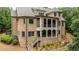 Spacious brick home with multiple porches, stairs, and manicured landscaping at 930 Shepards Ct, Roswell, GA 30075