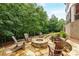 Inviting stone fire pit with Adirondack chairs surrounded by a lush, wooded landscape at 930 Shepards Ct, Roswell, GA 30075