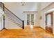 Lovely foyer boasts hardwood floors and staircase with decorative black iron banister at 930 Shepards Ct, Roswell, GA 30075