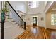 Grand foyer with soaring ceilings, elegant staircase, hardwood floors, and detailed trim work at 930 Shepards Ct, Roswell, GA 30075
