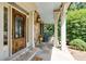 Charming front porch featuring stone accents, decorative wooden door, and comfortable seating at 930 Shepards Ct, Roswell, GA 30075