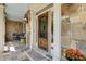 Detailed view of front porch with stone facade, ornate door, and beautiful landscaping at 930 Shepards Ct, Roswell, GA 30075