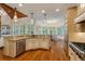 Open-concept kitchen with stainless appliances, granite countertops, an island, and hardwood floors at 930 Shepards Ct, Roswell, GA 30075