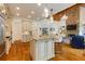 Open concept kitchen with granite counters, an island with seating, and access to the living room at 930 Shepards Ct, Roswell, GA 30075