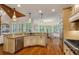 Open kitchen with granite countertops, hardwood floors, and a view to the breakfast nook and dining area at 930 Shepards Ct, Roswell, GA 30075