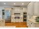 Updated kitchen with stainless steel appliances, custom cabinetry, granite countertops, and hardwood floors at 930 Shepards Ct, Roswell, GA 30075