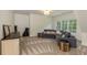 Spacious living room featuring neutral carpet, ample natural light, and a cozy sectional at 930 Shepards Ct, Roswell, GA 30075