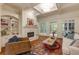 Inviting living room with fireplace, built-in shelving, coffered ceilings, and access to the outdoor deck at 930 Shepards Ct, Roswell, GA 30075