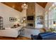 Inviting living room with vaulted ceilings, a stone fireplace, built-in bookshelves, and hardwood floors at 930 Shepards Ct, Roswell, GA 30075