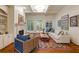 Cozy living room with fireplace, built-in shelving, coffered ceiling, and access to the outdoor deck at 930 Shepards Ct, Roswell, GA 30075