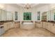 Lavish bathroom featuring and vanities, a soaking tub, and large windows with a backyard view at 930 Shepards Ct, Roswell, GA 30075