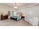 Spacious main bedroom featuring a chandelier, carpeted floors, tray ceiling and lots of natural light at 930 Shepards Ct, Roswell, GA 30075