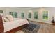 Spacious main bedroom with large windows, hardwood floors, tray ceiling, and elegant furnishings at 930 Shepards Ct, Roswell, GA 30075