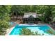 Community clubhouse and pool with lounge chairs near the playground, surrounded by trees at 930 Shepards Ct, Roswell, GA 30075