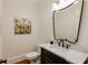 Modern powder room with black vanity, marble countertop, framed mirror, and stylish fixtures at 930 Shepards Ct, Roswell, GA 30075