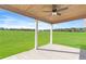 Covered porch with a ceiling fan, concrete flooring, and beautiful views of the green yard at 102 Red Oak Ln, Carrollton, GA 30116