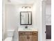Bathroom featuring vanity, quartz countertop, modern lighting, and a doorway to a closet at 102 Red Oak Ln, Carrollton, GA 30116