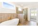 Spa-like bathroom featuring a freestanding tub and glass enclosed shower at 102 Red Oak Ln, Carrollton, GA 30116