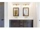 Bathroom featuring double vanity with dark cabinets, white countertop, and chrome fixtures at 102 Red Oak Ln, Carrollton, GA 30116