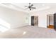 Spacious bedroom featuring neutral carpet, tray ceiling, and black trim at 102 Red Oak Ln, Carrollton, GA 30116
