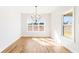 Dining room boasts a modern chandelier and large windows providing natural light and scenic views at 102 Red Oak Ln, Carrollton, GA 30116