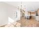 Spacious dining room features hardwood floors and a modern chandelier with views into kitchen and living room at 102 Red Oak Ln, Carrollton, GA 30116