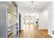 Entryway with hardwood floors, a modern light fixture, and a view into the living room at 102 Red Oak Ln, Carrollton, GA 30116