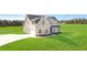 Exterior of a two-story home with grey siding, brick accents, and a large front yard at 102 Red Oak Ln, Carrollton, GA 30116