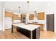 Open kitchen features large island, stainless steel appliances, modern lighting, and lots of storage space at 102 Red Oak Ln, Carrollton, GA 30116