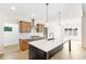 This kitchen features a large island, modern stainless appliances, and beautiful countertop with a backsplash at 102 Red Oak Ln, Carrollton, GA 30116