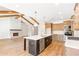Kitchen and Living Room boasts wood beam accents, stainless appliances, fireplace and an open concept at 102 Red Oak Ln, Carrollton, GA 30116