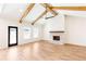 Open living room with wood flooring, vaulted ceilings, beams, and a brick fireplace at 102 Red Oak Ln, Carrollton, GA 30116