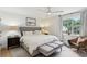 Serene bedroom featuring a plush bed, neutral decor, and a window with a view of the outdoors at 1767 Defoor Nw Ave # D, Atlanta, GA 30318