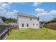 Spacious backyard with green grass, white vinyl siding, and fenced perimeter at 27 Autumn Canyon Se Path, Cartersville, GA 30121