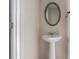 This bathroom features a pedestal sink, decorative mirror and fresh neutral paint at 27 Autumn Canyon Se Path, Cartersville, GA 30121