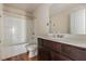 Clean bathroom with single sink vanity, wood look flooring and tub with shower at 27 Autumn Canyon Se Path, Cartersville, GA 30121