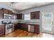 This kitchen offers stainless steel appliances, granite countertops, wood floors and dark wood cabinets at 27 Autumn Canyon Se Path, Cartersville, GA 30121
