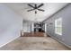 Open-concept living room flowing into the kitchen, featuring hardwood floors and ample space for entertaining and dining at 27 Autumn Canyon Se Path, Cartersville, GA 30121