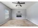 Large main bedroom with carpet, a ceiling fan, and a cozy fireplace, providing a comfortable retreat at 27 Autumn Canyon Se Path, Cartersville, GA 30121