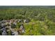An aerial view of homes nestled in a lush, green, wooded landscape at 550 Vinings Springs Se Dr, Smyrna, GA 30126