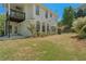 Backyard view of the home featuring a balcony, windows and lush greenery surrounding the property at 550 Vinings Springs Se Dr, Smyrna, GA 30126