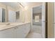 Bathroom boasts a double sink vanity, large mirror, and tile floor at 550 Vinings Springs Se Dr, Smyrna, GA 30126