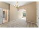 Bright bedroom featuring a chandelier, neutral walls, and plush carpeting at 550 Vinings Springs Se Dr, Smyrna, GA 30126
