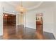 Open-concept dining room with hardwood floors, stylish chandelier, and seamless flow to other living spaces at 550 Vinings Springs Se Dr, Smyrna, GA 30126