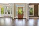 Bright foyer showcasing hardwood floors, a glass-paneled door, and natural light with easy access to adjacent rooms at 550 Vinings Springs Se Dr, Smyrna, GA 30126